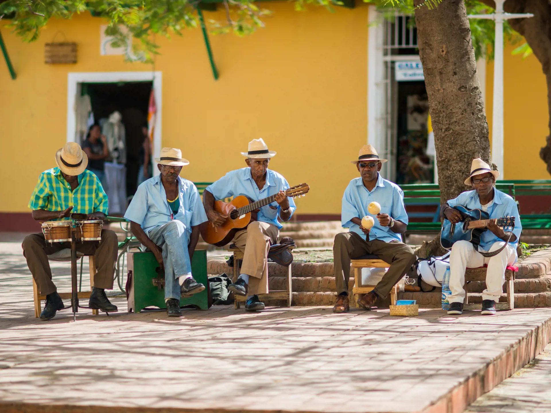 shutterstock_512230474 TRINIDAD, CUBA - APRIL 06, 2014 Group of Latino American men of musicians play on maracases, guitar and small drums a.jpg
