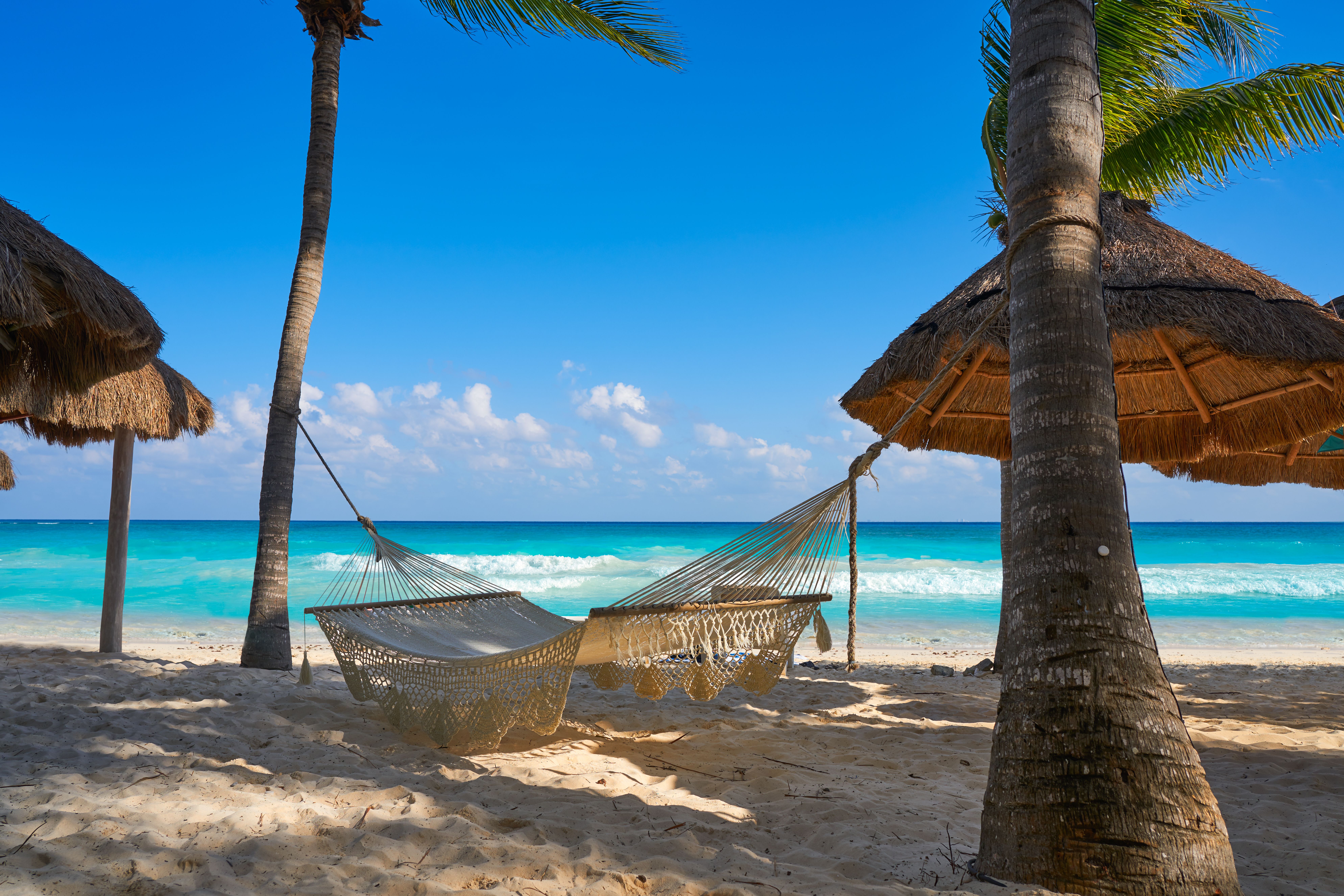 shutterstock_740944774 Playa del Carmen beach hammocks in Riviera Maya Caribbean at Mayan Mexico.jpg
