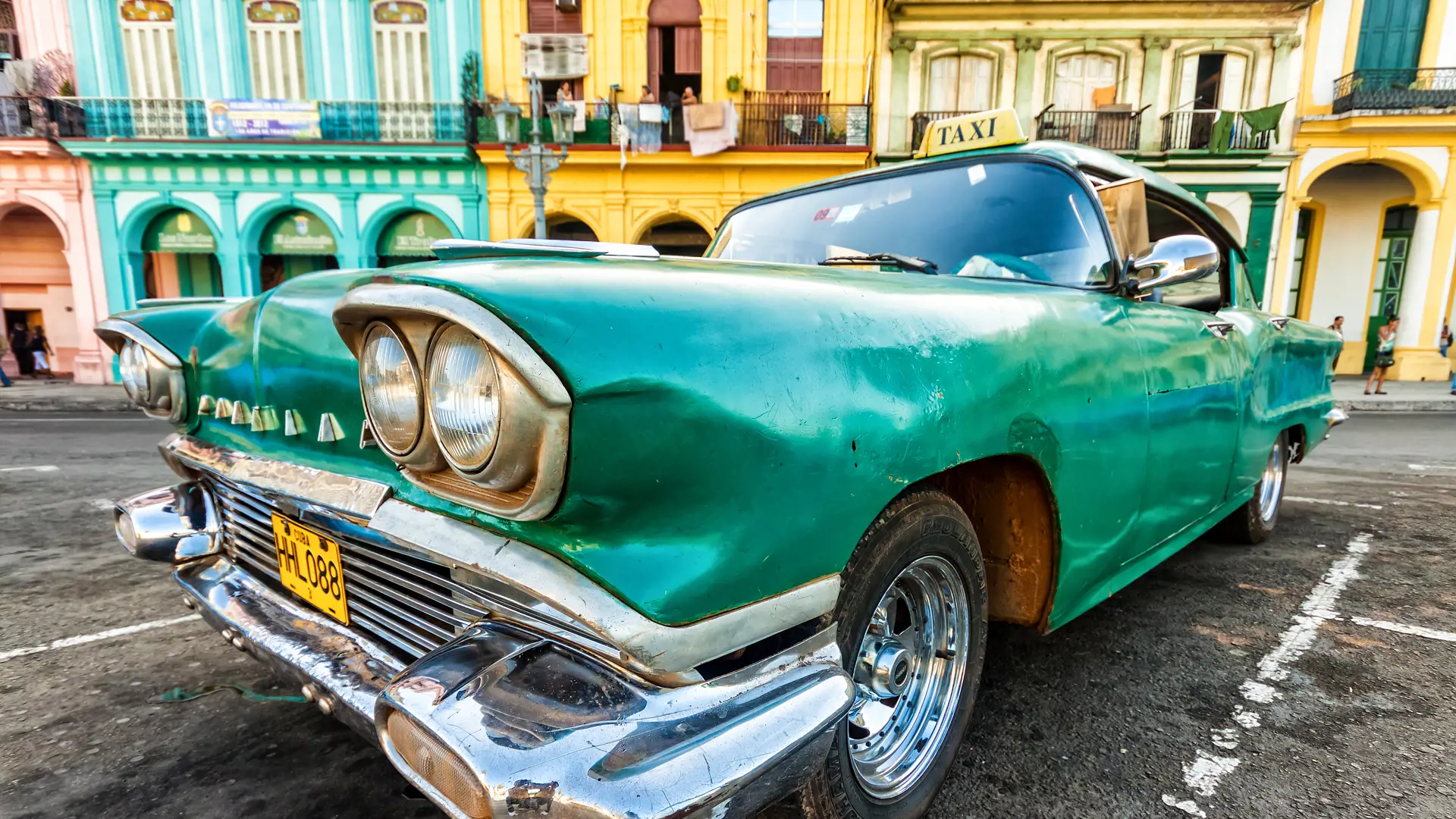 shutterstock_110700959 Vintage Cadillac in a colorful neighborhood August 14,2012 in Havana.jpg