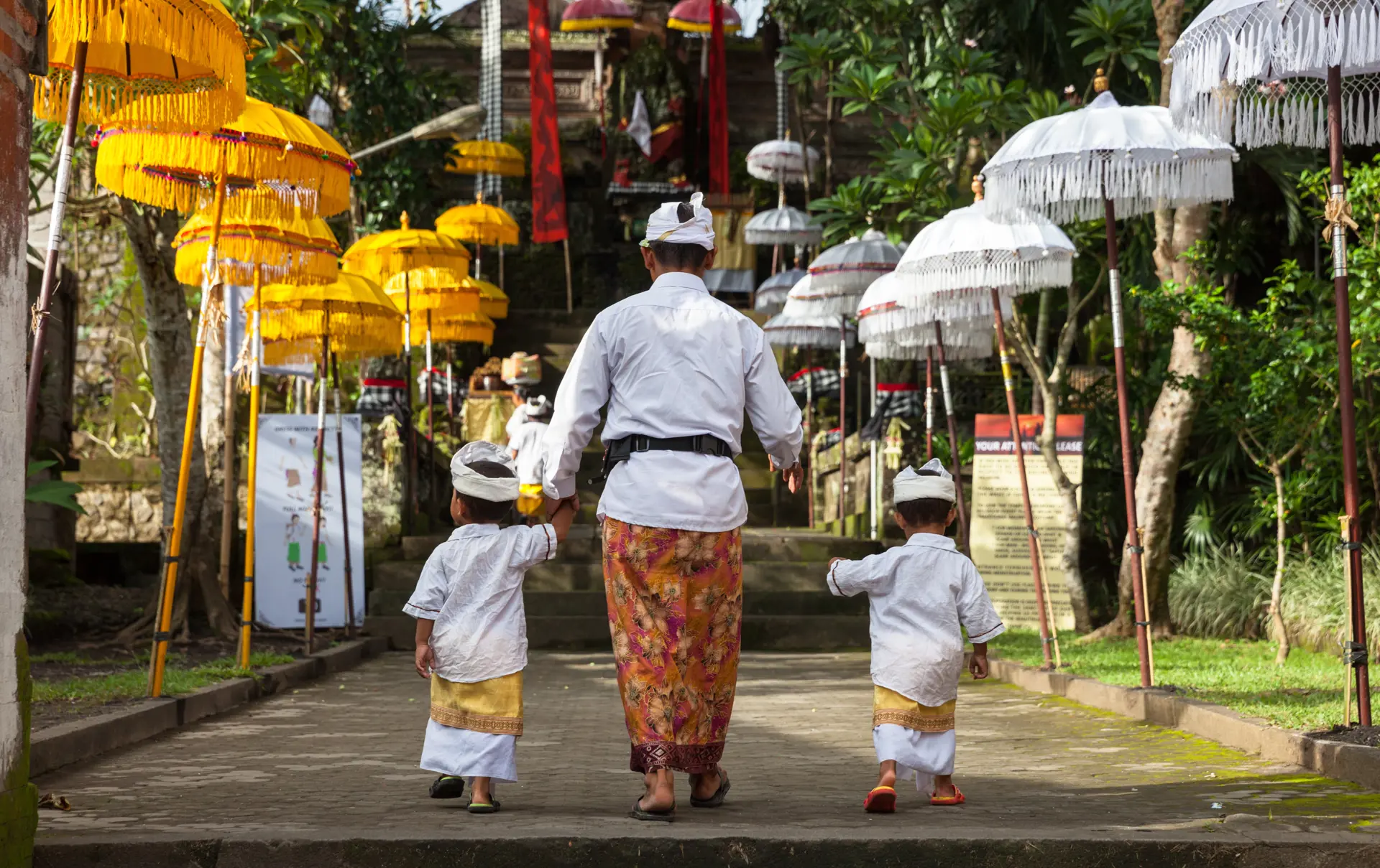 UBUD, INDONESIA - MARCH 2 Man with children walks up the stairs during the celebration before Nyepi (Balinese Day of Silence).jpg