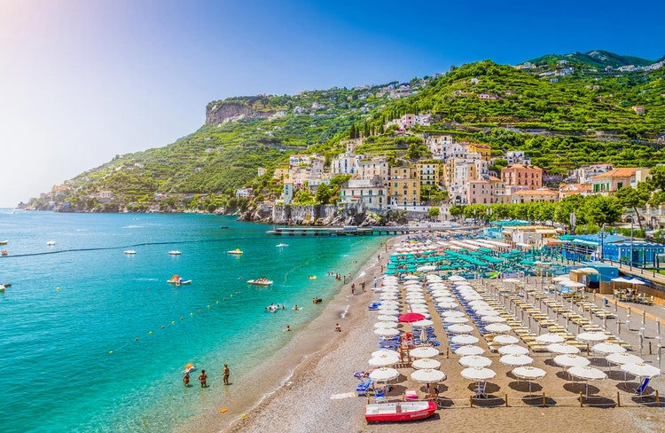 Du kan hyra solstolar och parasoller på stranden i Minori
