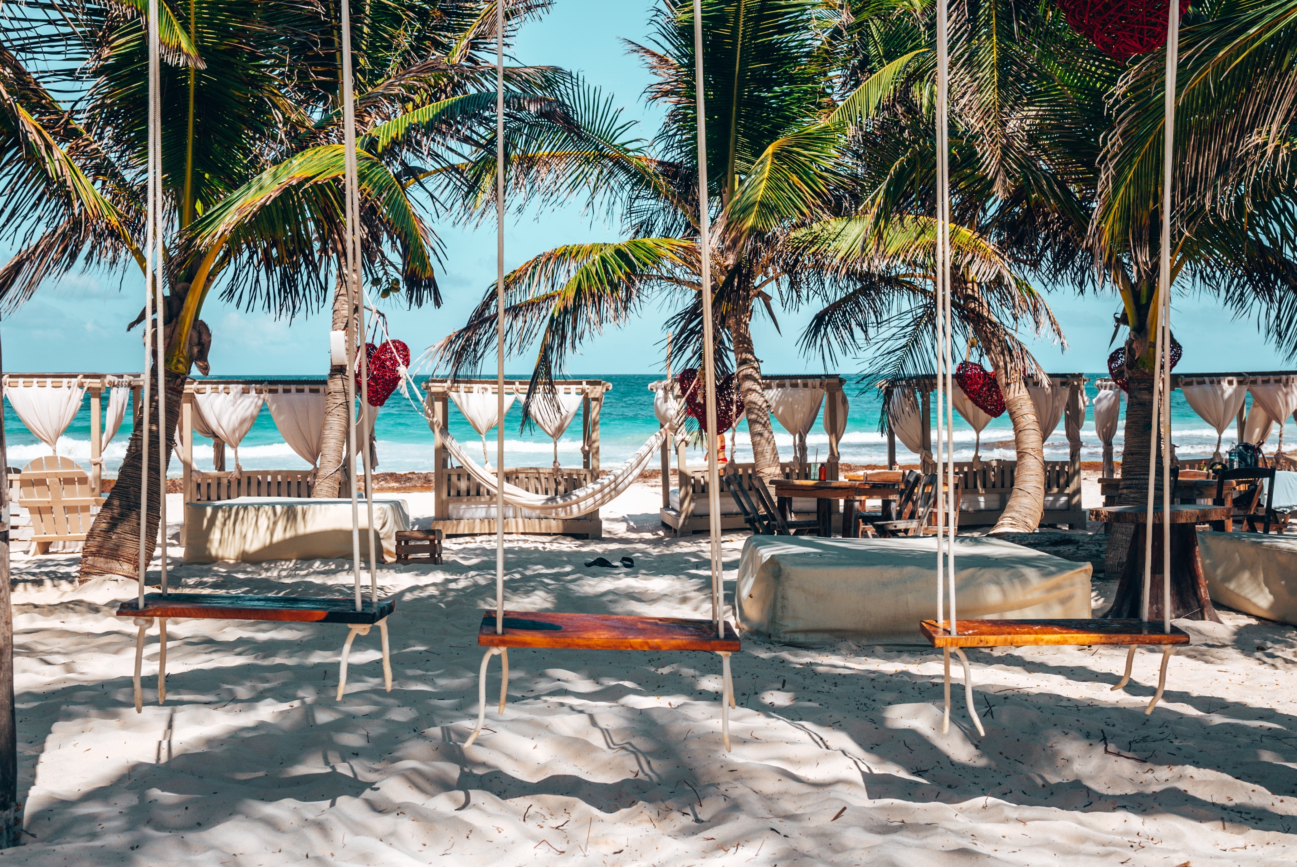 Shutterstock 2042010641 Hanging Wooden Swing Seats Tied Up With Rope On Sand At Beautiful Beach Resort With Canopy, In Tulum, Mexico.