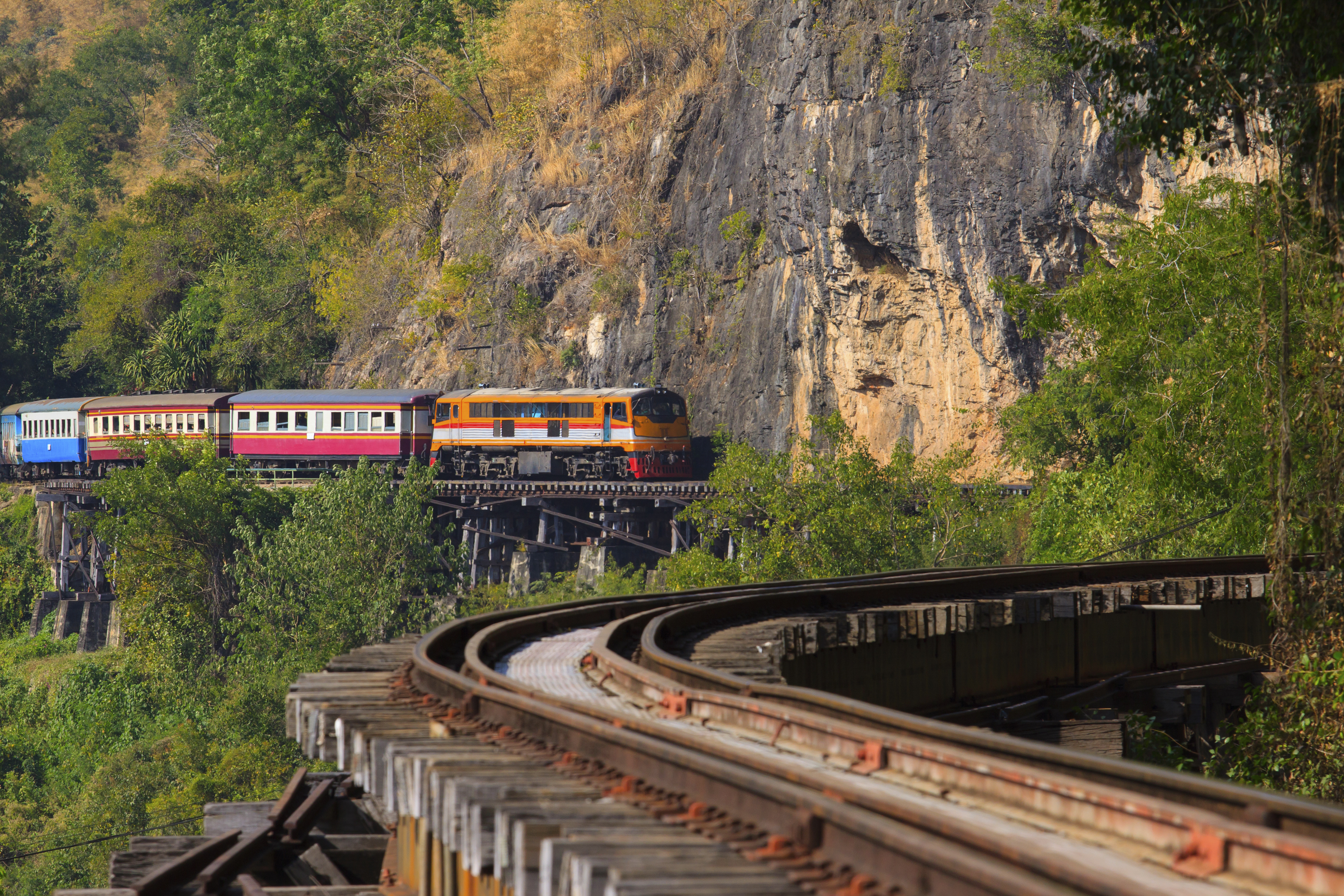 shutterstock_239065714 trains running on death railways crossing kwai river in kanchanaburi border of thailand-myanmar important landmark.jpg