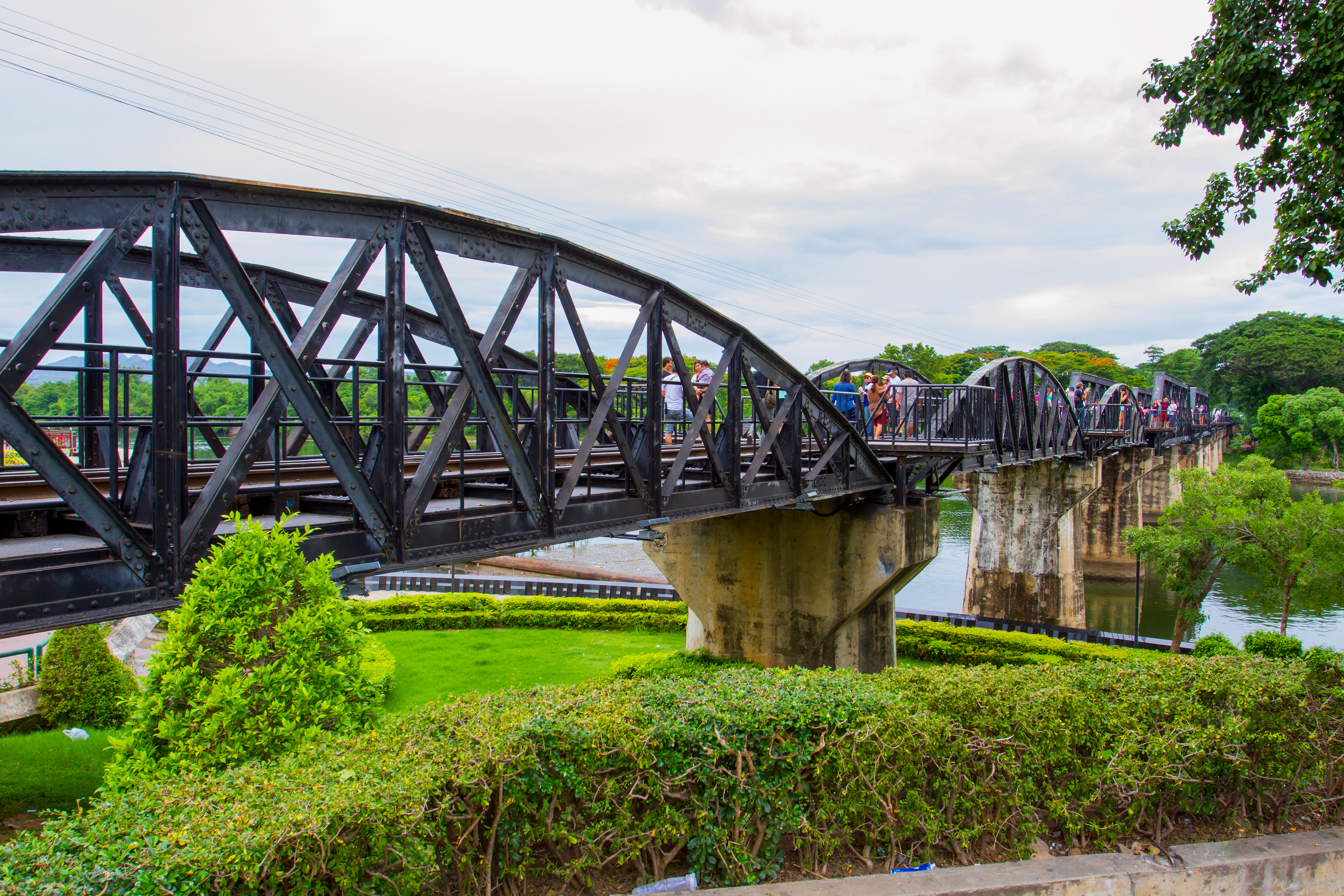 Tourists on the bridge over the river Kwai (Khwae) in Kanchanaburi, Thailand on Ju (1).jpg