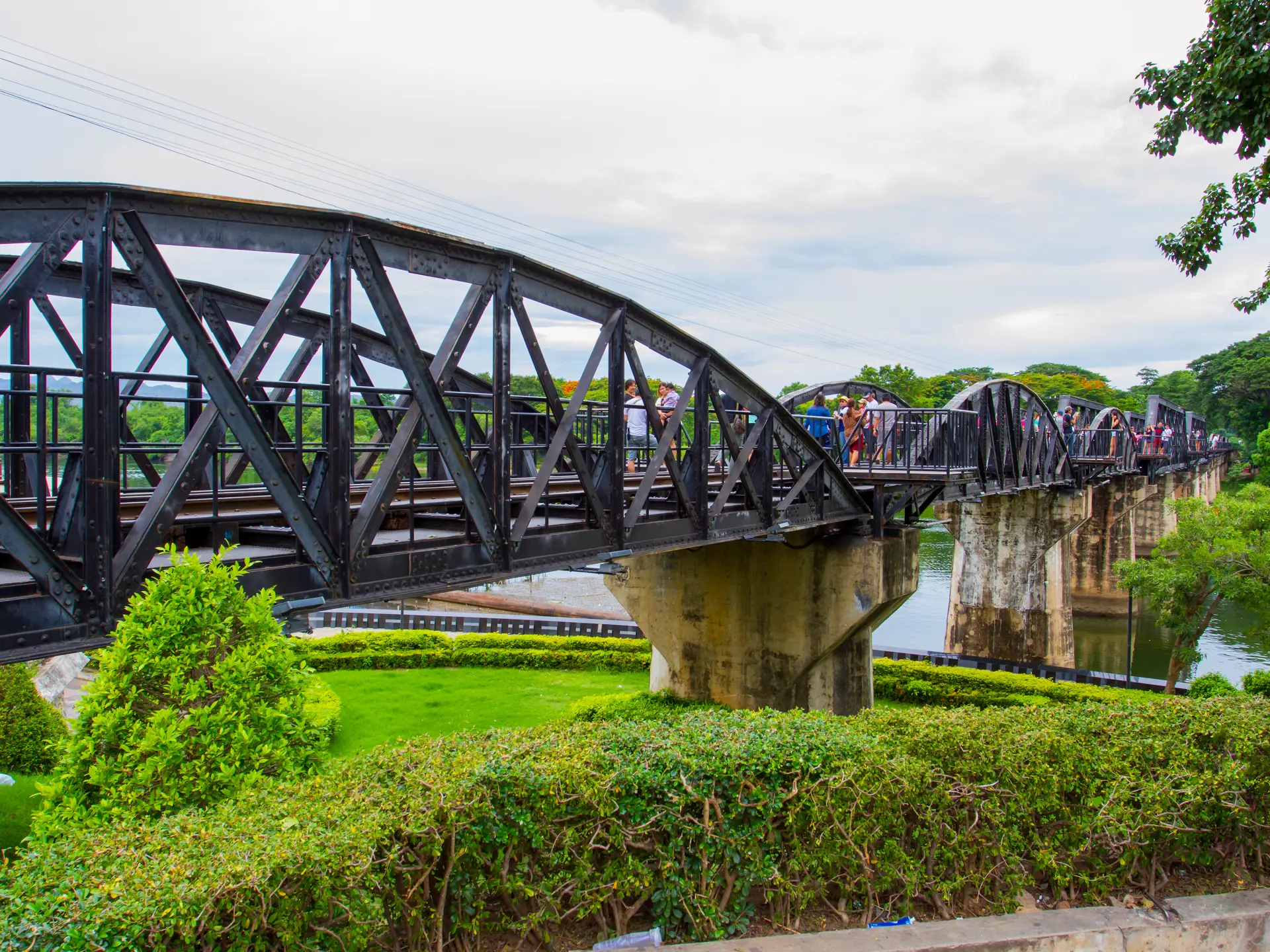 Tourists on the bridge over the river Kwai (Khwae) in Kanchanaburi, Thailand on Ju (1).jpg