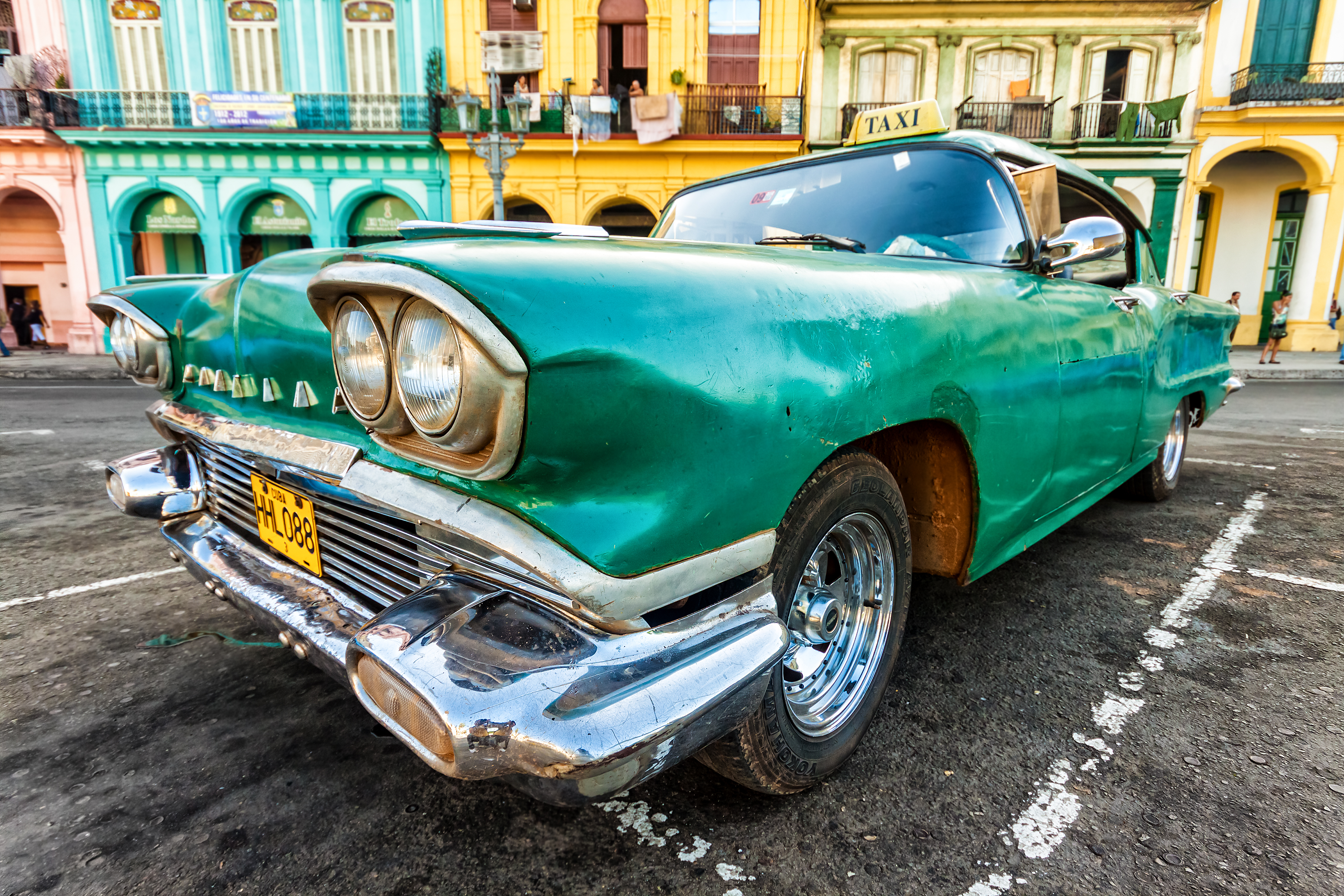 shutterstock_110700959 Vintage Cadillac in a colorful neighborhood August 14,2012 in Havana.jpg