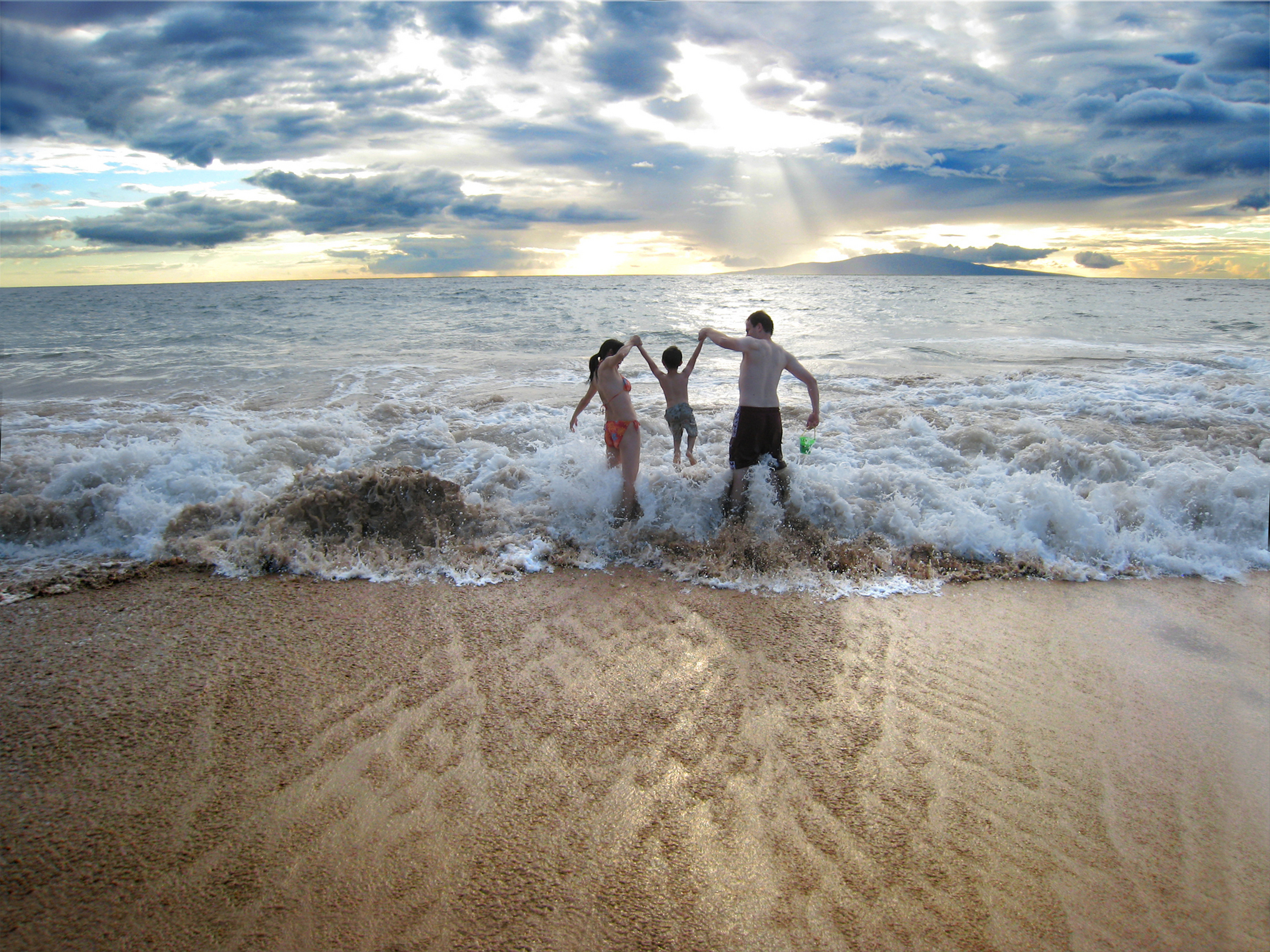 Mom, 3years old and Dad having fun in the waves_5690287.jpg