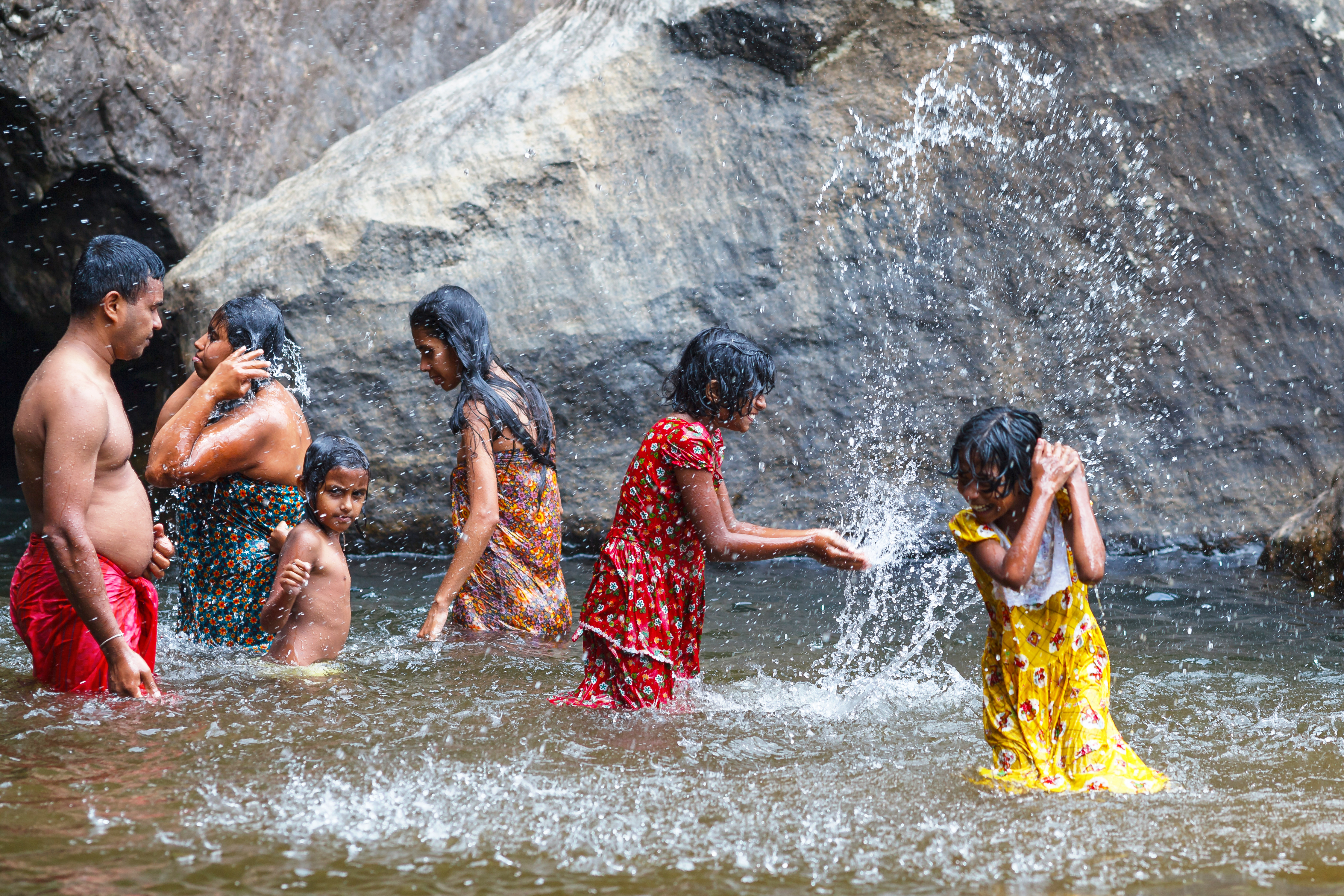 shutterstock_505768432 BAMBARAKANDA WATERFALL, SRI LANKA, MARCH 13 2016 local family bathes in a waterfall..jpg