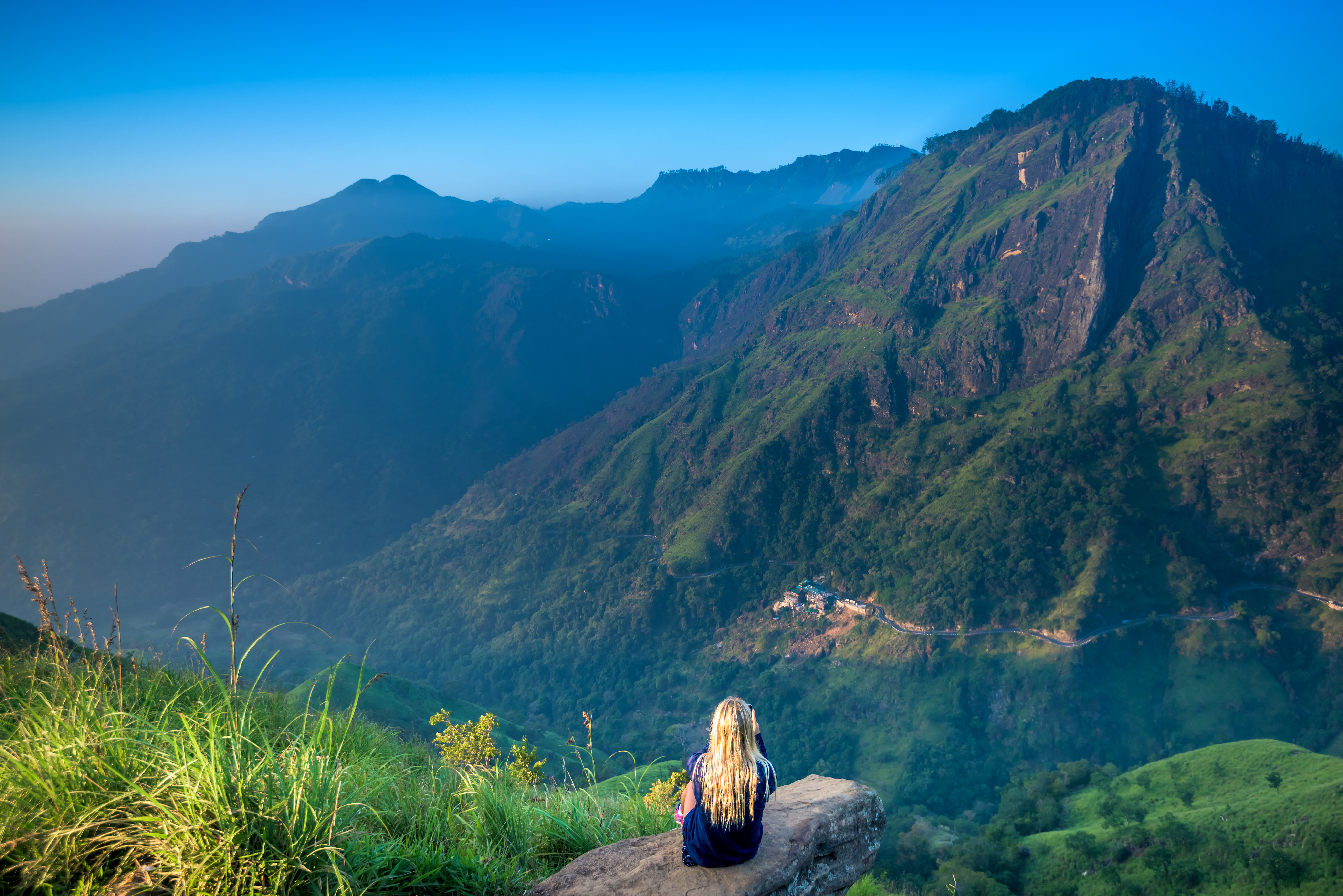 shutterstock_599412806 Tourist girl at beautiful landscape in Little Adams's peak, Ella, Srilanka.jpg