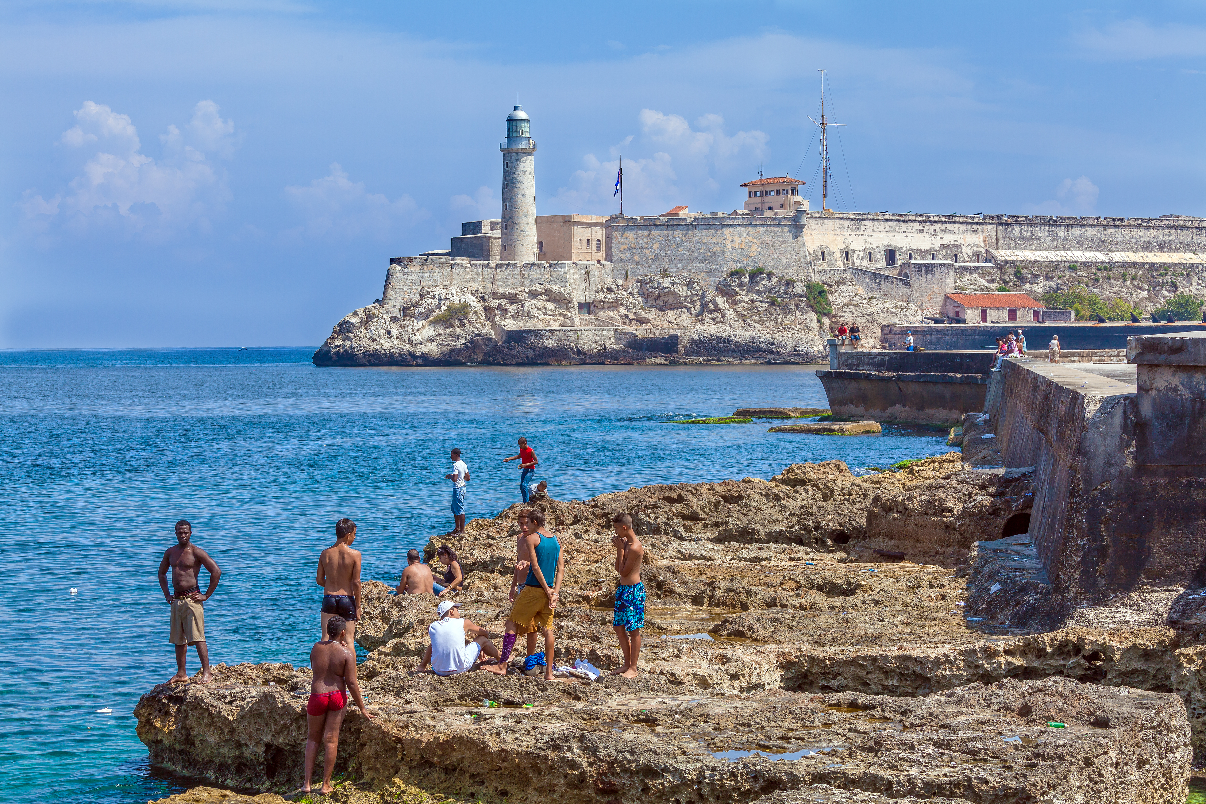 shutterstock_392267488HAVANA, CUBA - APRIL 1, 2012 Teenagers swimming in Caribbean sea near Moro castle.jpg