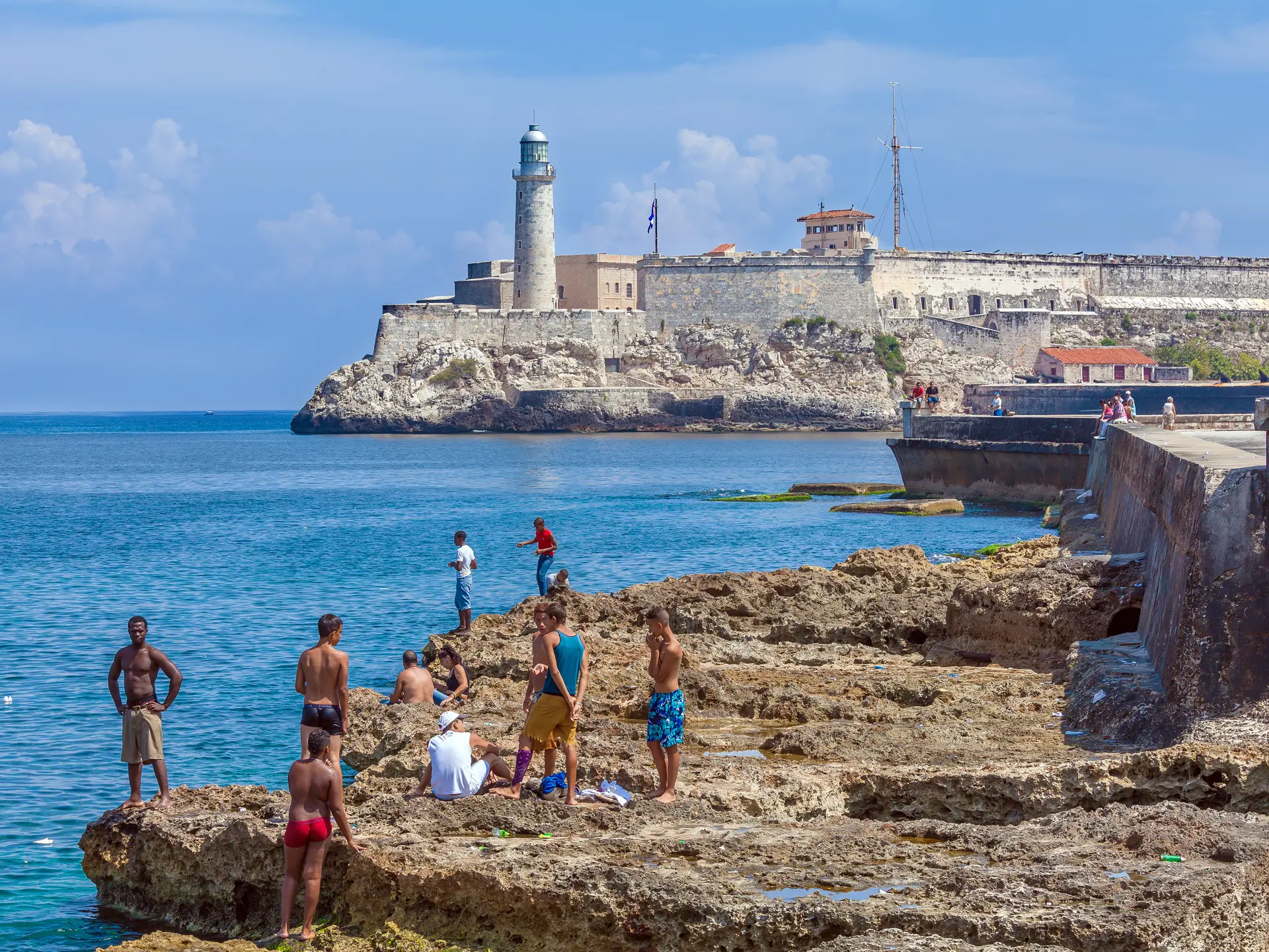 shutterstock_392267488HAVANA, CUBA - APRIL 1, 2012 Teenagers swimming in Caribbean sea near Moro castle.jpg