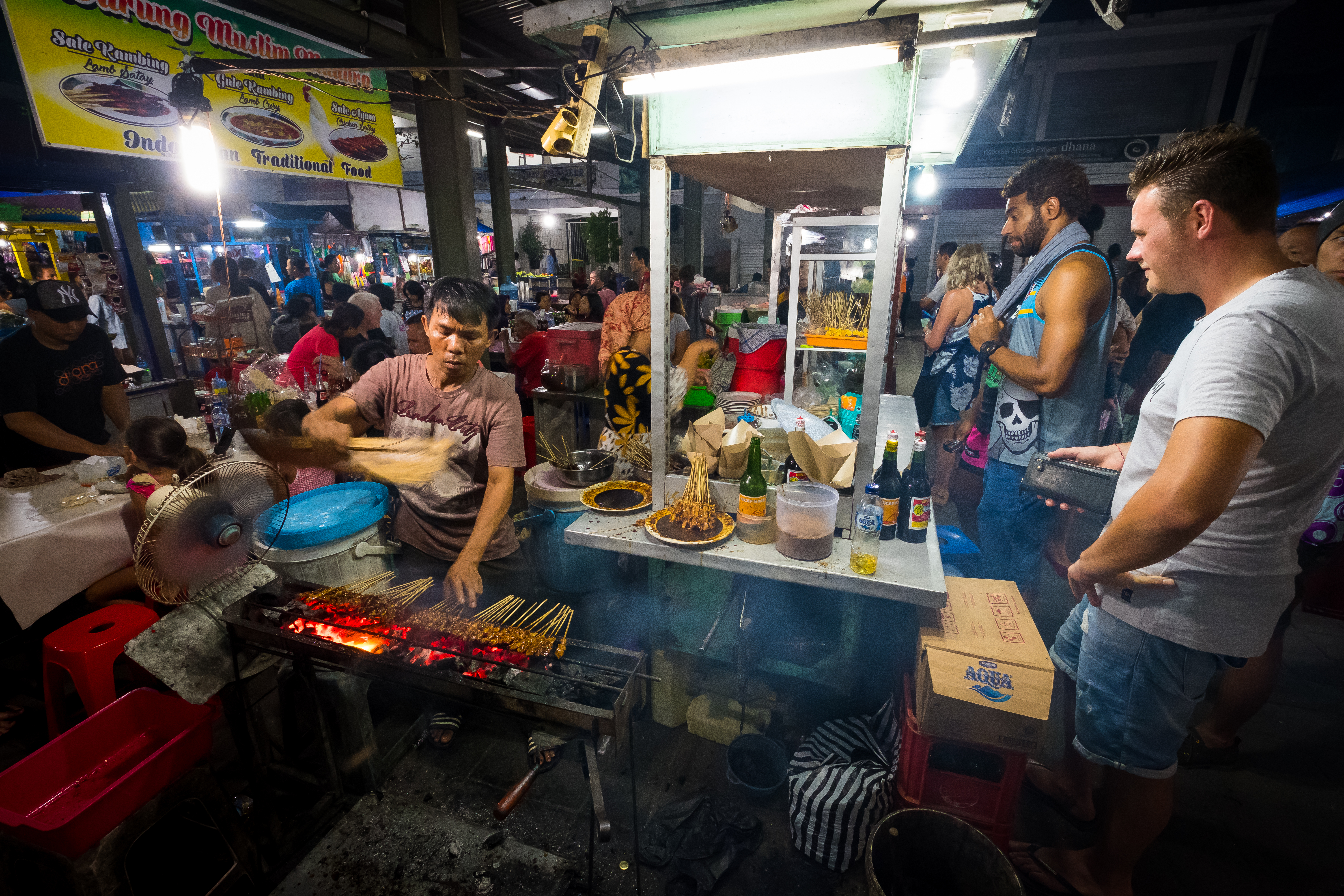 Sanur, Bali Indonesia December 28 2017 Scene Of A Worker At The Local Night Market With Customer Surrounding