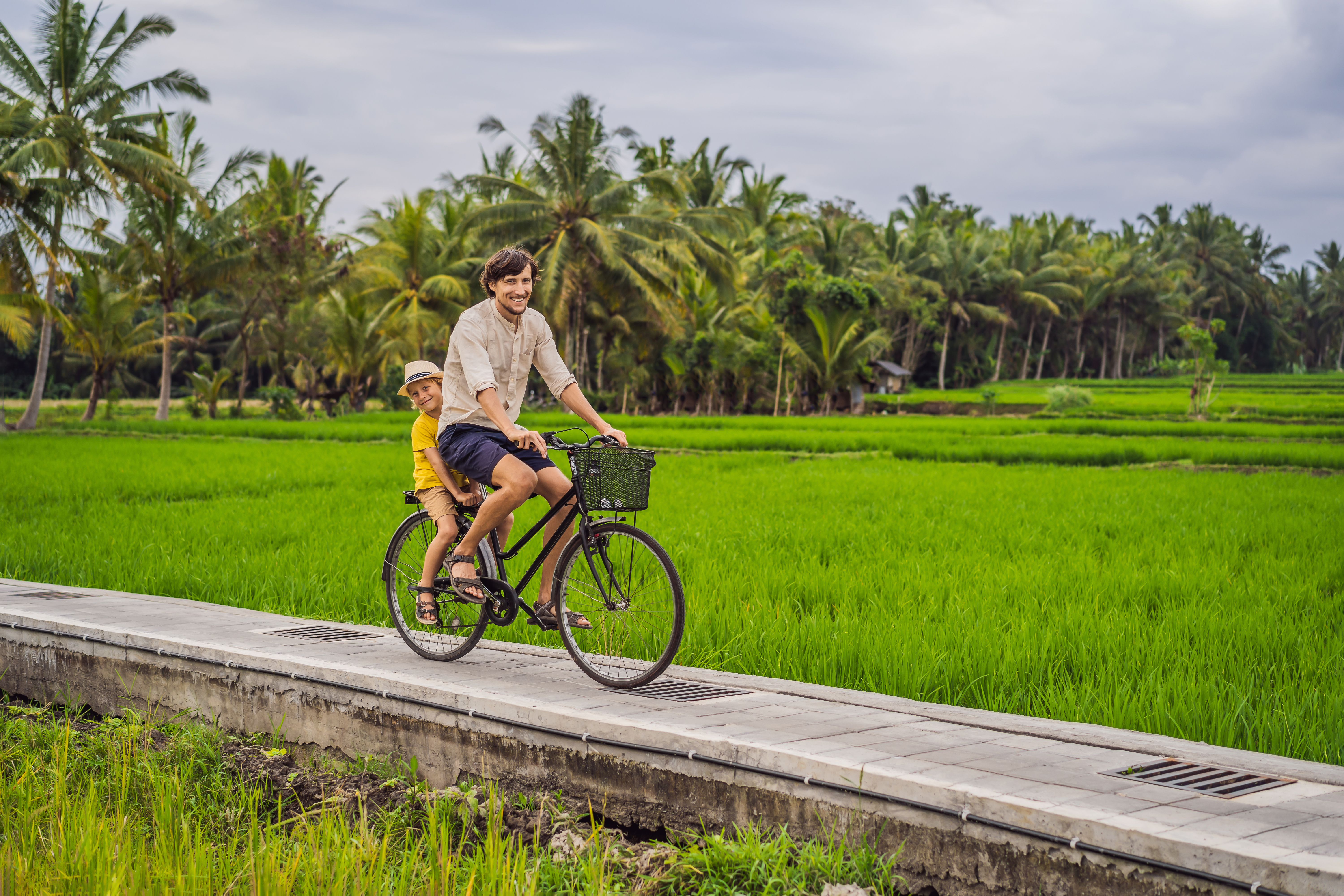 Shutterstock 1546168523 (Father And Son Ride A Bicycle On A Rice Field In Ubud, Bali. Travel To Bali With Kids Concept)
