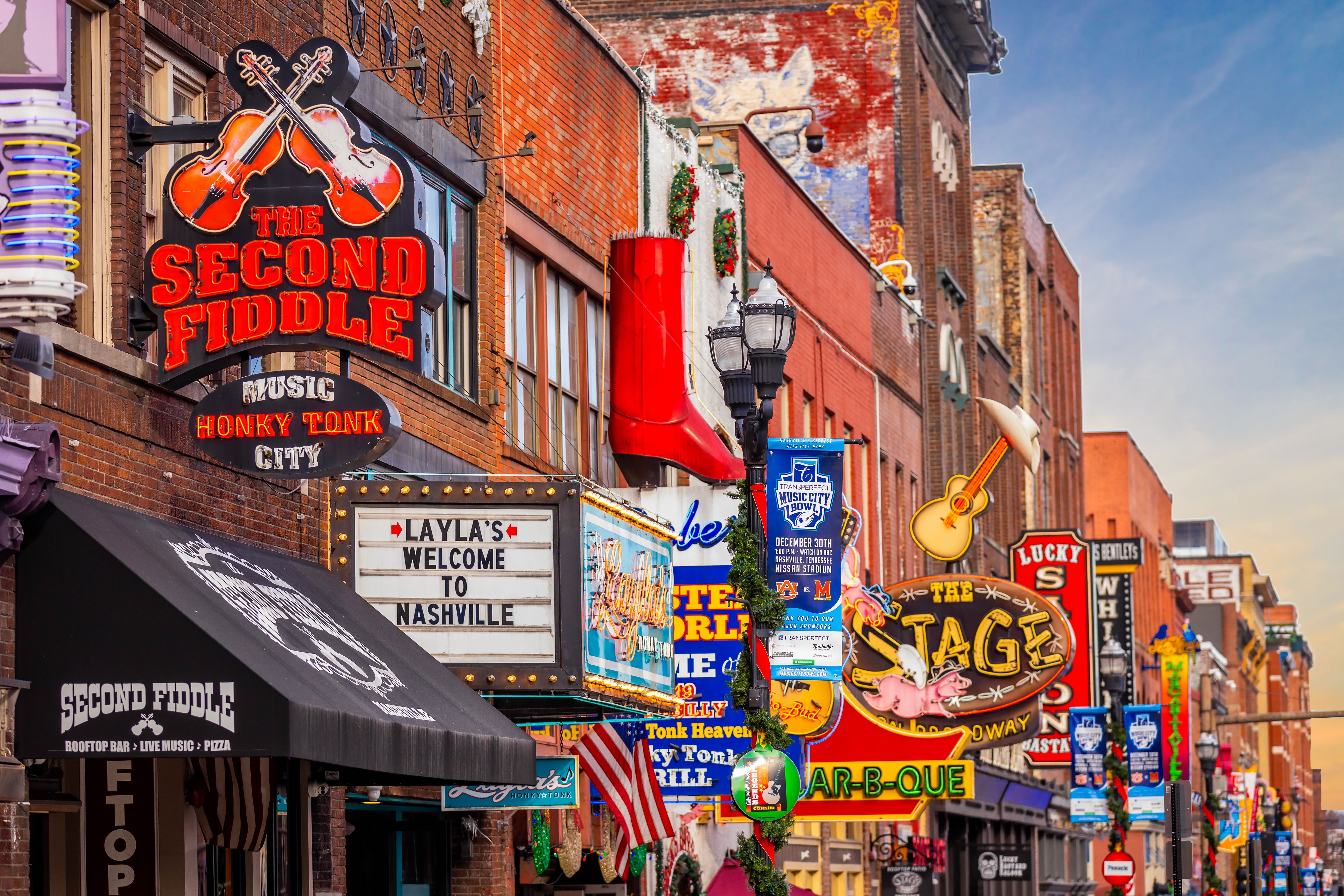 Shutterstock 2418513121 Nashville, TN, USA 12 24 2023 Famous Neon Signs Of Blues Clubs On Beale Street At Day In Downtown Nashville City Attraction